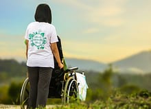 woman pushing wheelchair 